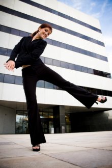 Woman dancing in front of office building
