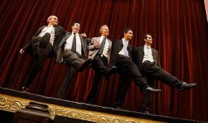 Men dancing in a row